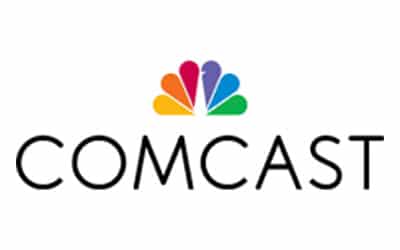 The image shows the Comcast logo with the company name "COMCAST" in black text below a colorful, rainbow-peacock design.