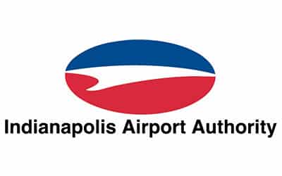 Logo of Indianapolis Airport Authority featuring an abstract design with a blue and red oval, resembling a wing, and text below that reads "Indianapolis Airport Authority.